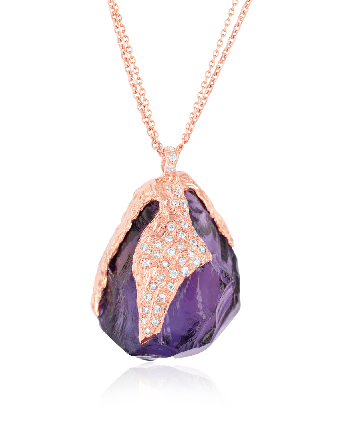 Detailed view of Natalie Dissel 18K rose gold necklace featuring a raw Amethyst stone capped with pavé white diamonds, Gem Rocks collection.