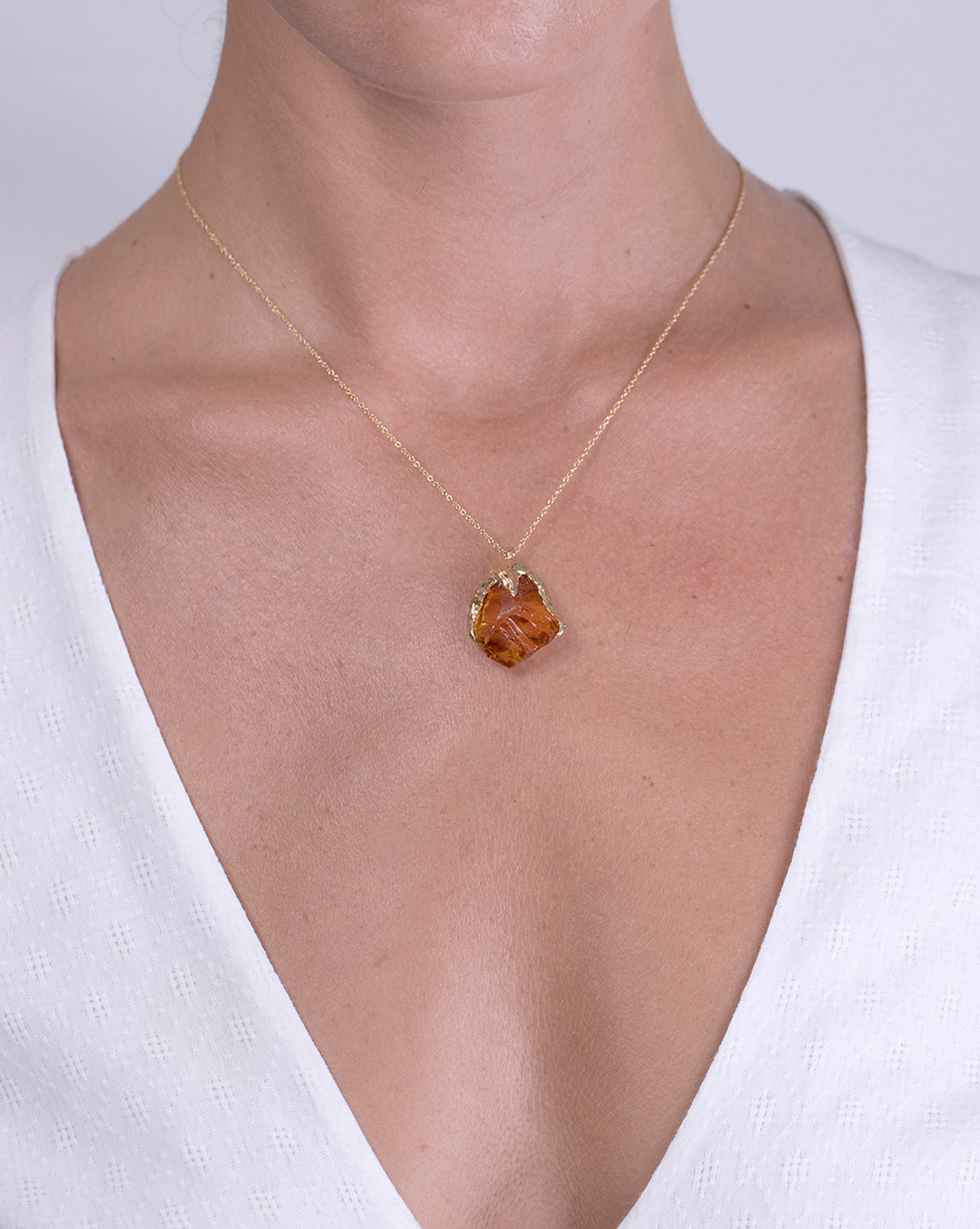 Model shot showcasing a high quality recycled 18K Yellow Gold necklace with a raw citrine pendant