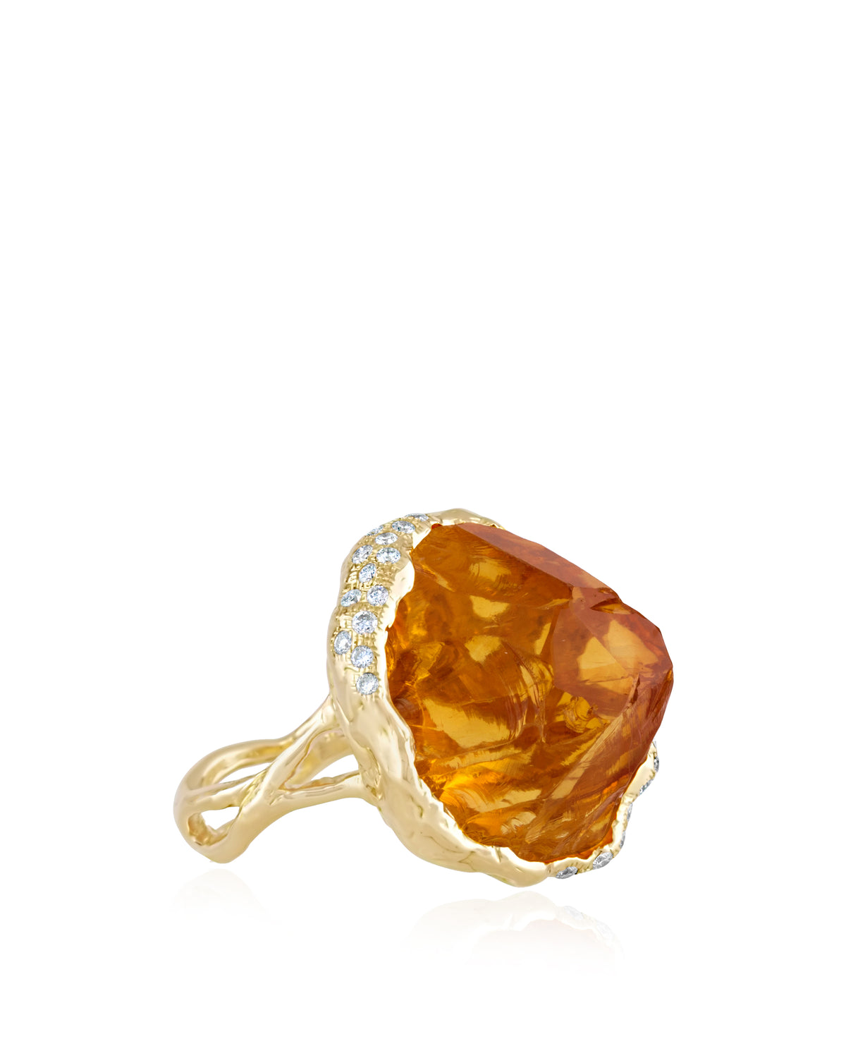 Side perspective of a high-jewellery 18K yellow gold ring featuring an organic, rough-cut amber citrine gemstone trimmed with small pavé diamonds along a textured, split-branch band.