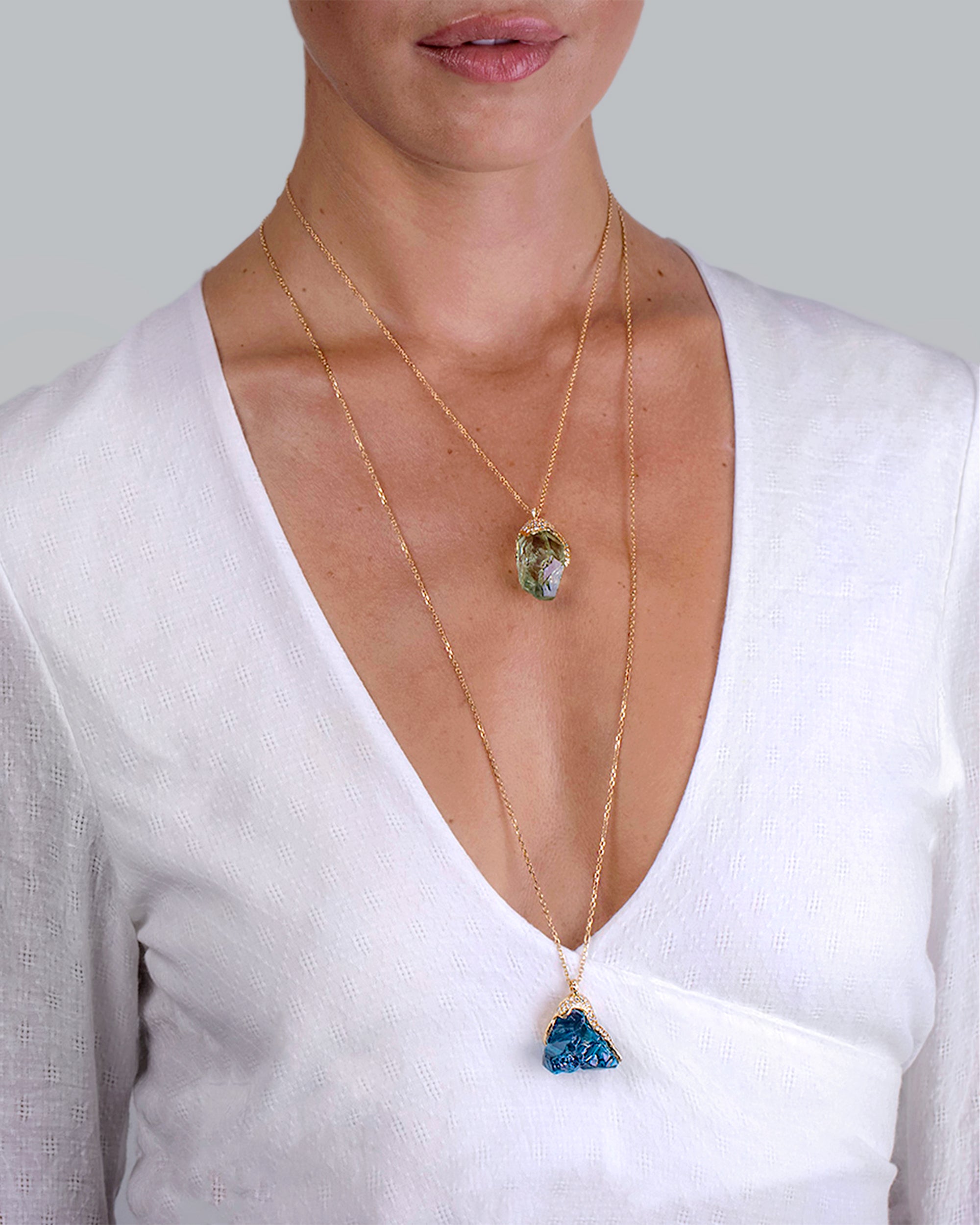 Model wearing the Natalie Dissel 18K yellow gold raw Prasiolite diamond pendant layered with another long gemstone necklace.