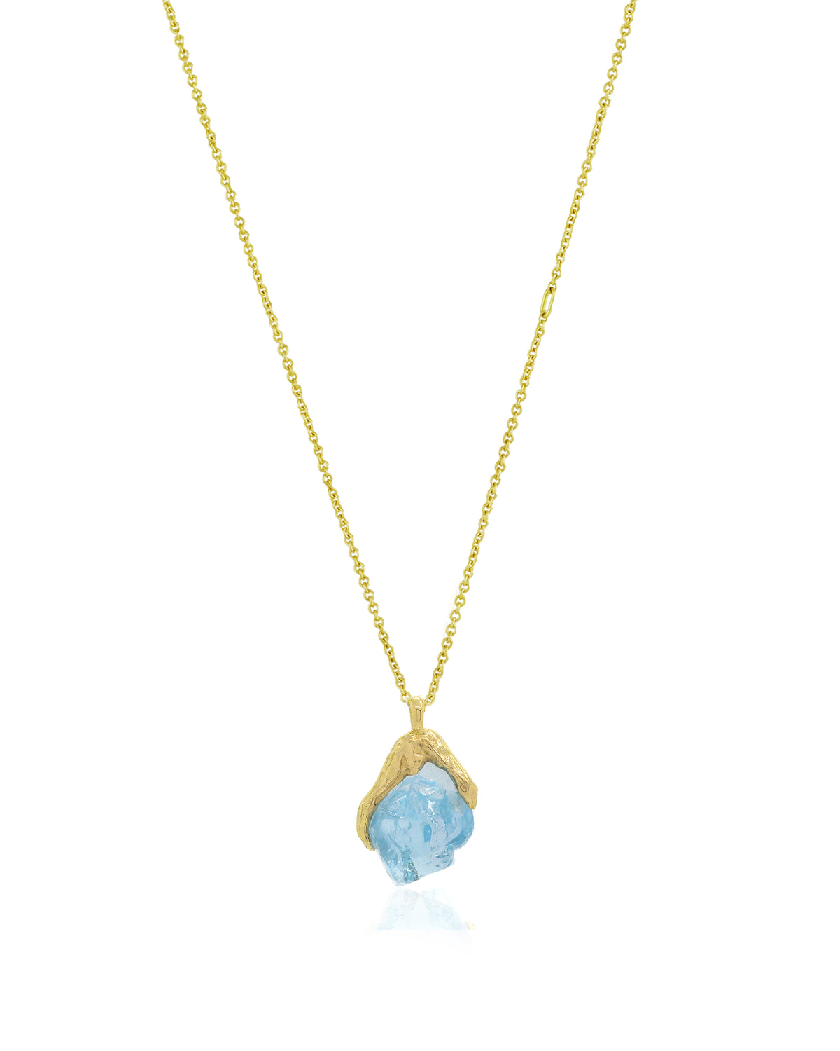 Front view of Natalie Dissel fine 18K yellow gold chain holding an uncut Sky Blue Topaz gemstone pendant set in molten gold, Gem Rocks collection.